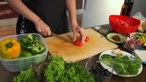 Woman Cutting Tomato and Preparing a Meal