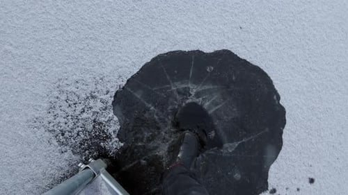 Breaking the Ice of a Frozen Lake With Feet in Lake Clermoustier, Petit-Chertsey, Canada - High Angl
