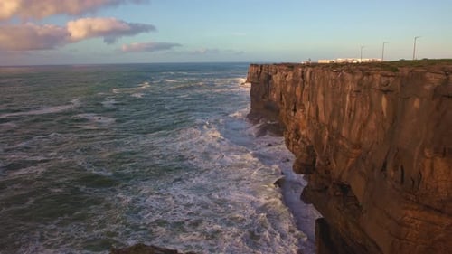 Nature Landscape Sea Waves Crash Against a Rocky Cliff at Golden Hour