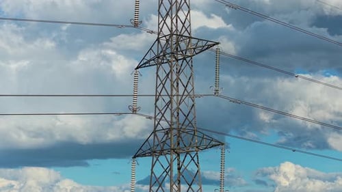 High Voltage Tower Section Showing Insulators Transmitting Electricity Through Power Lines Tall
