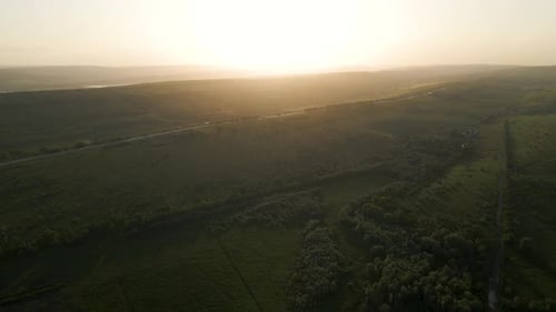 Aerial View of the Drone's Flight Over the Highway That Crosses the Agricultural
