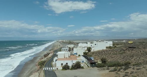 Aerial view of white buildings by ocean in Cabo de Gata National Park, Spain.