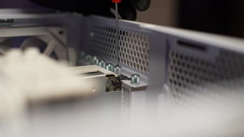 Closeup Technician Male in Gloves Screwing Cooler to Back of System Unit During Mounting Fan in