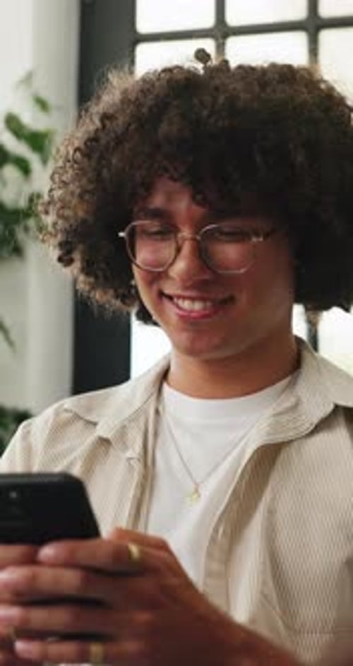 Home, relax and happy man in lounge, cellphone for online joke and digital app for social media