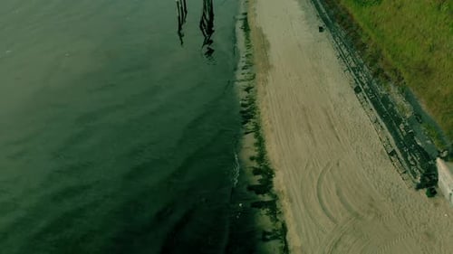 Aerial fotage on empty beach early morning. A peaceful sea with low waves.