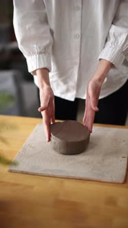 Hands Shaping Clay Pot on Table Indoors