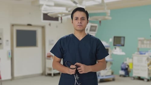 Focused Doctor in Scrubs in Modern Hospital Room
