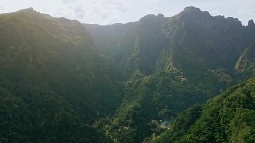 Aerial Rugged Green Rocks and Valleys with Steep Cliffs Landscape Dense Forests