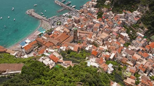 Aerial view of the Amalfi coast and town, showing a beautiful coastal buildings and crowded beach.