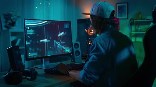 Man Playing Video Game in Dark Room