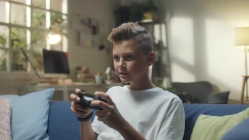 Teenage Gamer Playing Console at Home