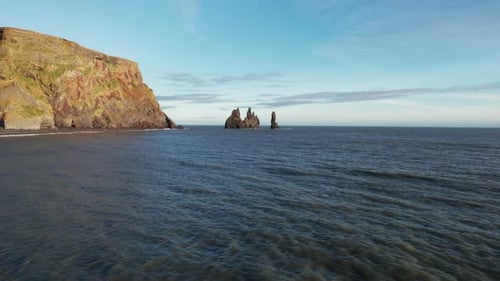 Rocky Basalt Formations Sticking Out Of Water Near Iceland South Coast In Reynisfjara Beach. Drone S