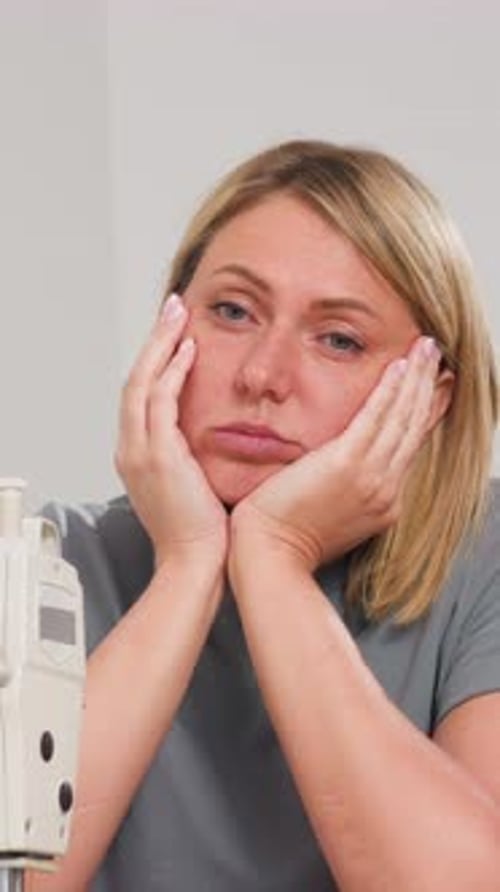 Woman with Chin in Hands Looking Bored Indoors