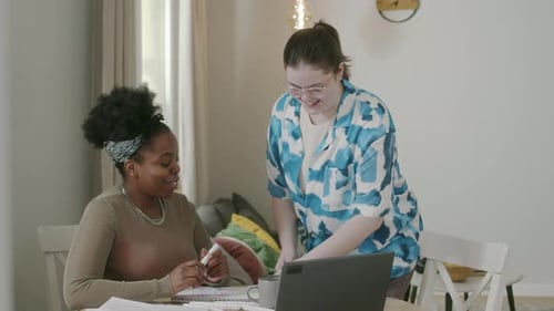 Two Young Women Talking Together at Home