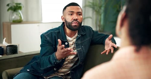Man Talking During Discussion on Sofa