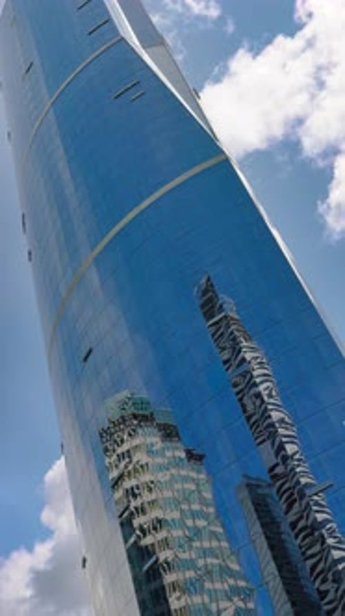 Time Lapse of Clouds Reflecting Into the Glass of a Large Office Building