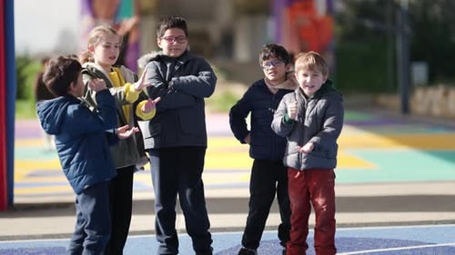 Group of Diverse Children Talking and Playing in a Playground