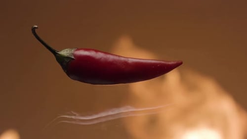 Floating Red Chili Pepper with Fire Background