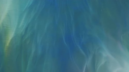 Abstract Green and Yellow Paint in Blue Liquid