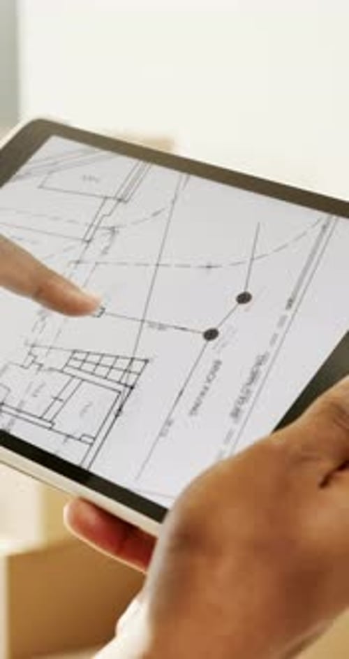 Hands, tablet screen and blueprint for renovation planning, construction or interior design of home