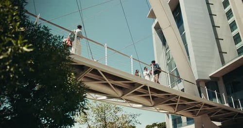 College, bridge and students with people from low angle in city for campus, education and future