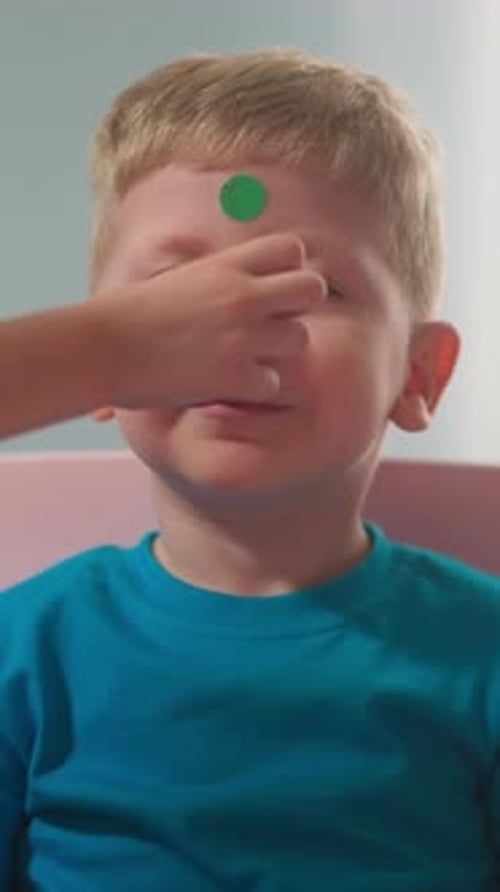 Child Gets Stickers on Face From Friend
