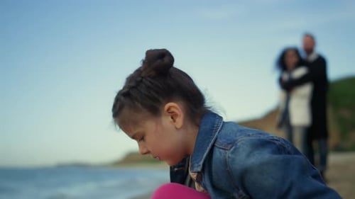 Young Girl Enjoying Beach Sunny Day on Family Vacation. Cute Kid Playing