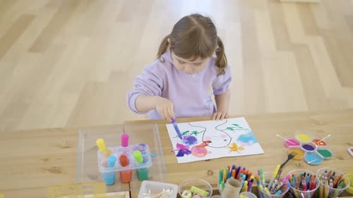 A Girl In A Workshop Class Doing Arts Using Watercolor. High Angle Shot