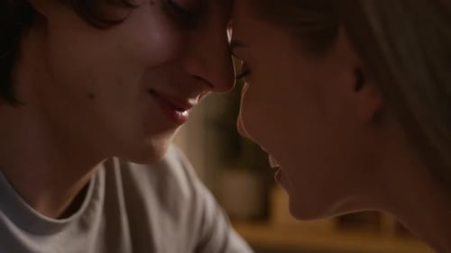 Affectionate Couple Sitting Close Kissing