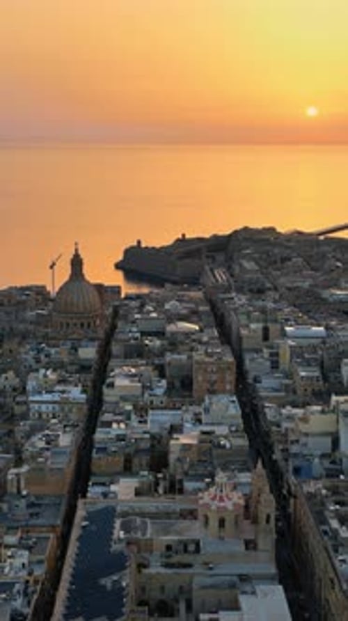 Aerial drone view of the walled city of Valletta, Malta, surrounded by the Mediterranean sea in the