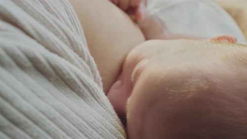 Mother Breastfeeding Her Baby Close Up