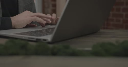 Employee Works on Contemporary Laptop Sitting at Table