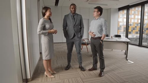 Three Multiethnic Businesspeople Having Talk in Office