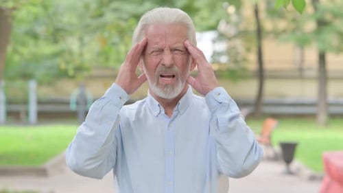 Outdoor Portrait of Tired Senior Old Man with Migrane