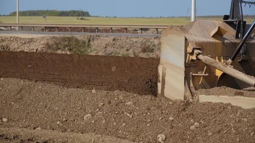 Earthmover Smooths Dirt on Rural Construction Site