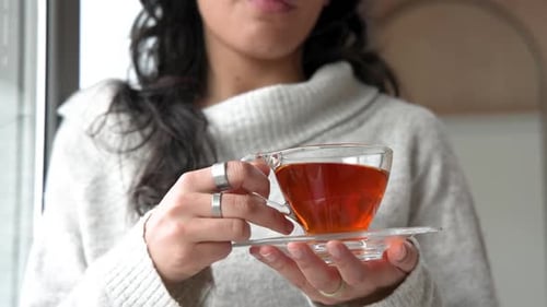 Woman Enjoying Hot Tea by Window