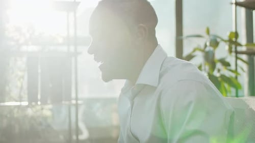 Excited Man Pumping Fist in Office Celebrating Success