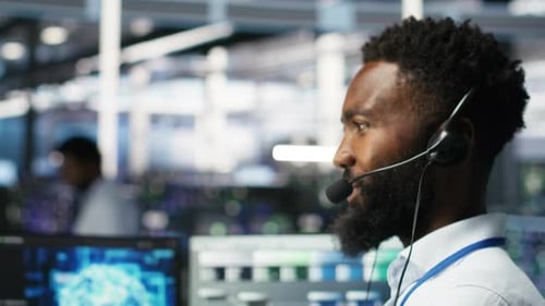 Data Center Employee Talking in Headset Mic Coordinating Technicians