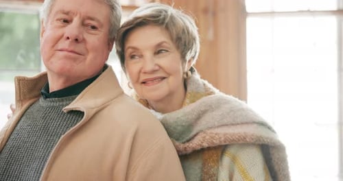 Smiling Senior Couple Embracing Indoors