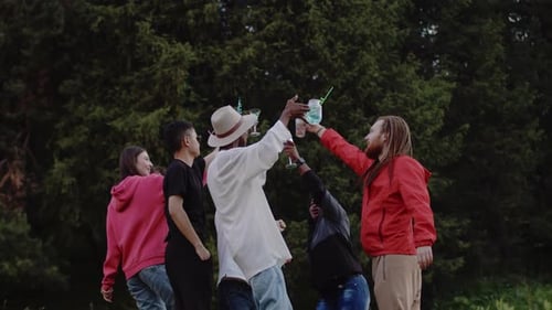 General View of a Young Multiracial Friends Dancing Together with Cocktails at the Cheerful Outdoor