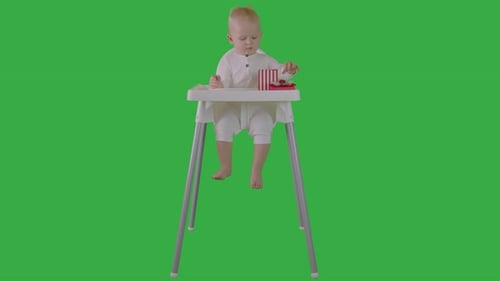 One Year Old Baby Boy Sitting On Chair And Make Present For Mom On Green Screen 1