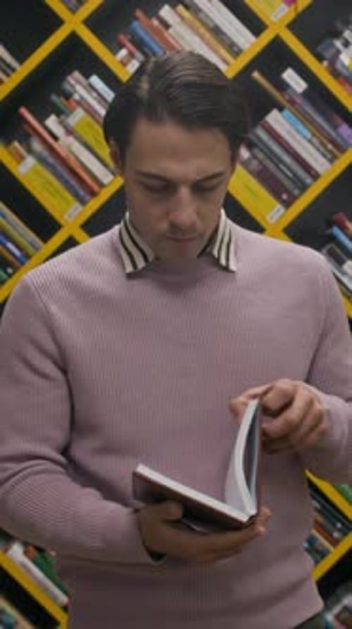 Vertical Portrait of Young Male Reader in Modern Library