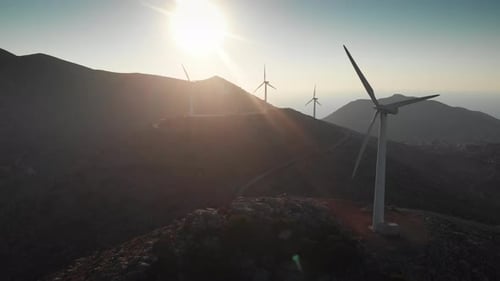 Modern power turbines on top of mountain against sky