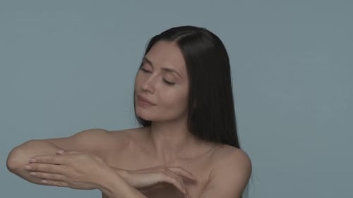 Portrait of a Seminude Woman in the Studio on a Blue Background Close Up A Woman Enjoys the Velvety
