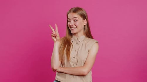 Woman Posing with Peace Sign on Pink Background