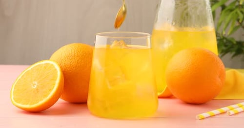Refreshing Orange Drink with Ice Cubes and Fruit