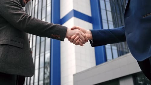 Two Business Man in Suit Shaking Hands Friendly Greeting to Each Other Outdoor Downtown Closeup