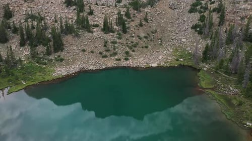 Green Amethyst Lake and Mirror Sky Reflection. Aerial View of Landscape Scenery at Uinta Mountain Ra