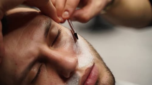 Man Having Face Shaved with a Straight Razor