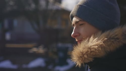 Portrait Confident Boy Looking Away in Warm Clothes at Street
